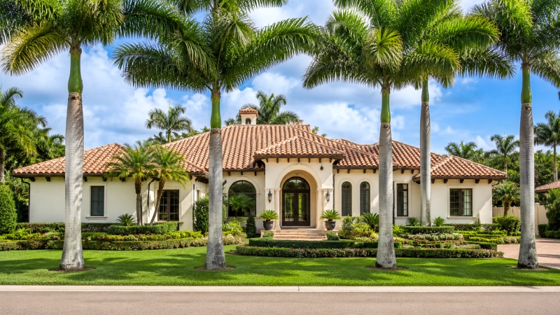 Single-family home in Fort Myers surrounded by tropical vegetation.